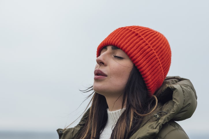 woman wearing a red hat breathing in calm