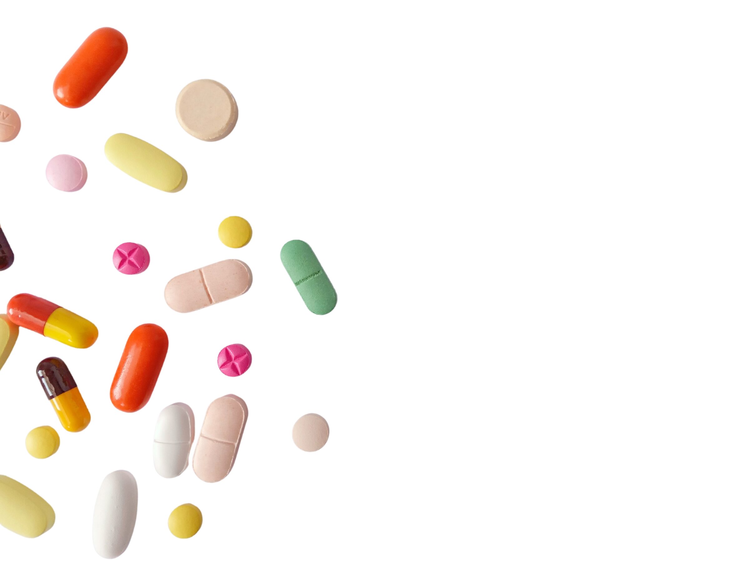 Variety of pills in front of a white background.