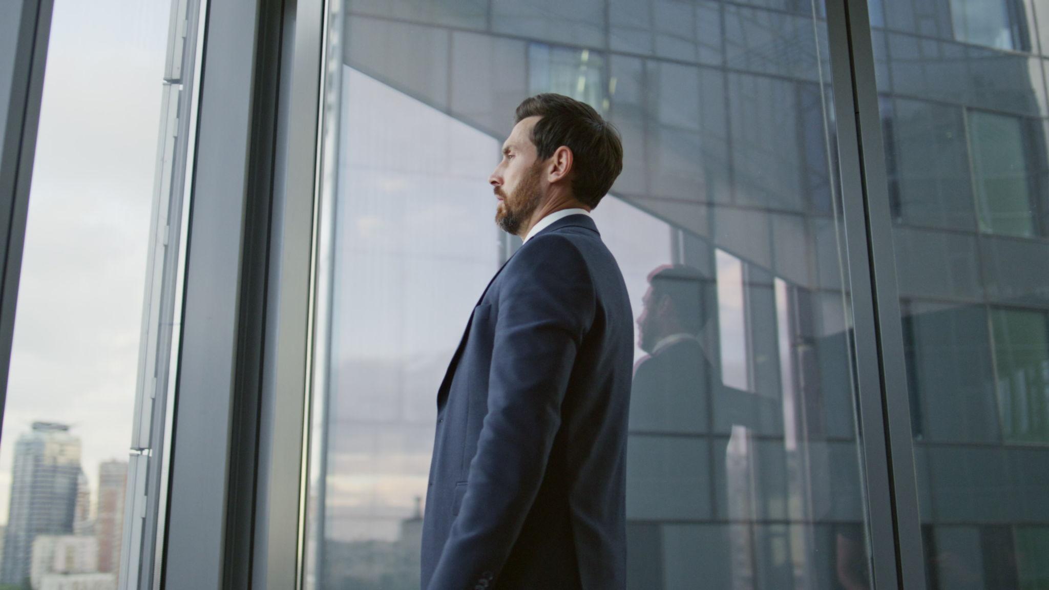 Man looks out a window.